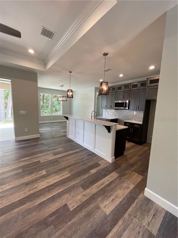 Great Room with Tray Ceiling into Kitchen and Dini