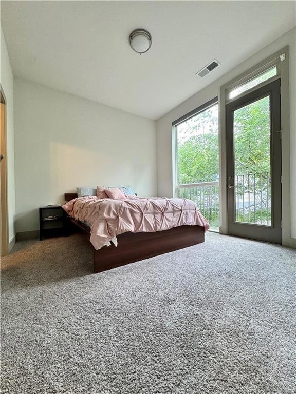 Carpeted bedroom featuring access to outside