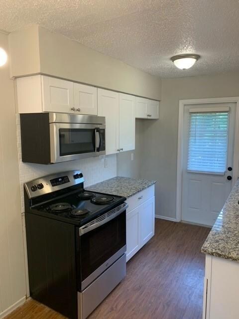 Kitchen with stainless steel appliances, a texture