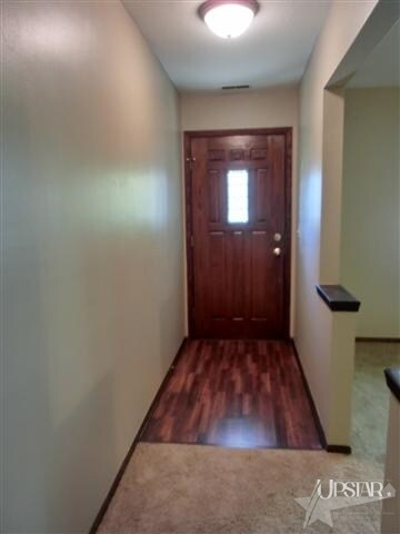 Foyer entrance with new door & wood floor