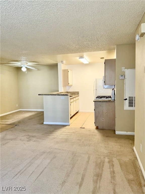 Kitchen with a textured ceiling, light colored car