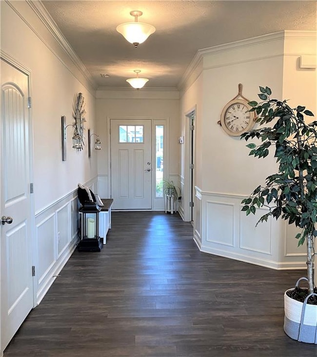 Stunning Entryway with Upgraded Doors, Vinyl Plank Flooring, & Custom Wainscoting!