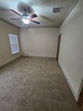 Carpeted empty room with a ceiling fan and electr