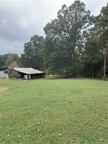 Endless possibilities on this 4.62 acre lot. Mature trees offer the ultimate privacy. All buildings convey