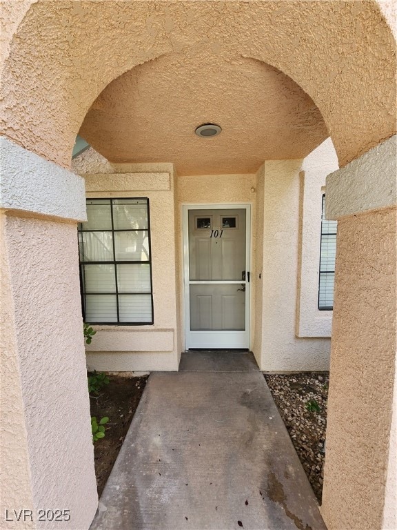 Property entrance with stucco siding