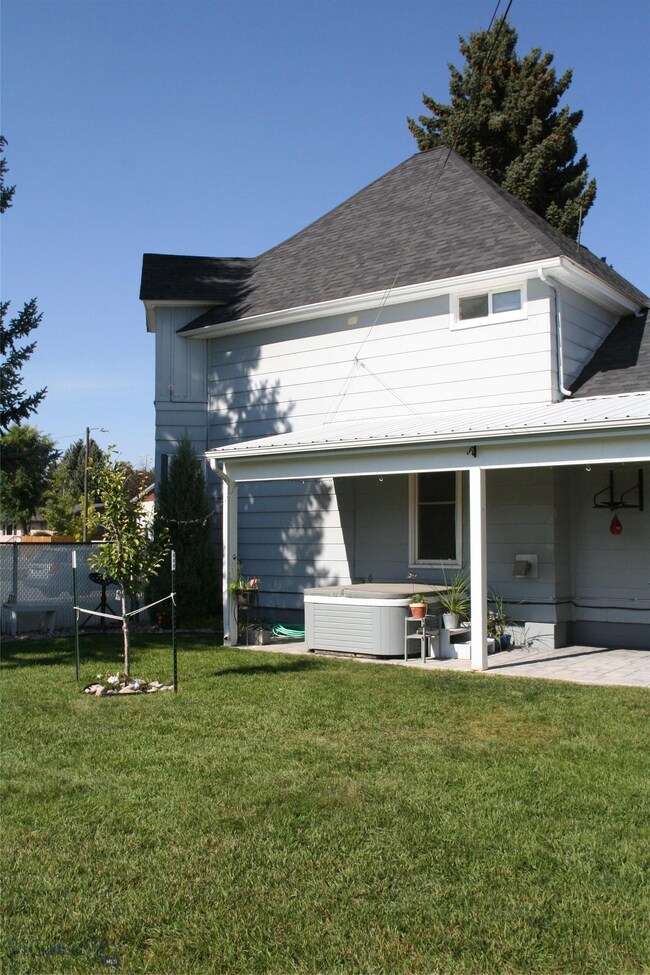 Large comfortable enclosed back yard with fruit tr