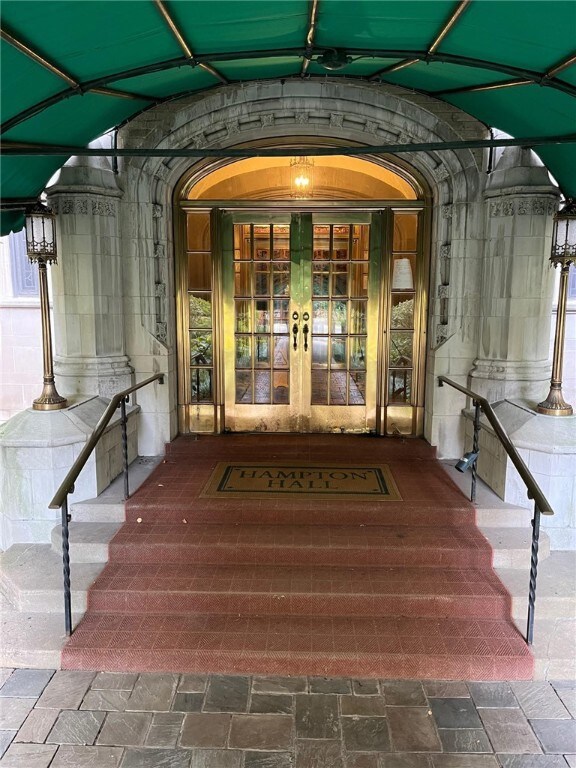 Cool green awning & brass doors.