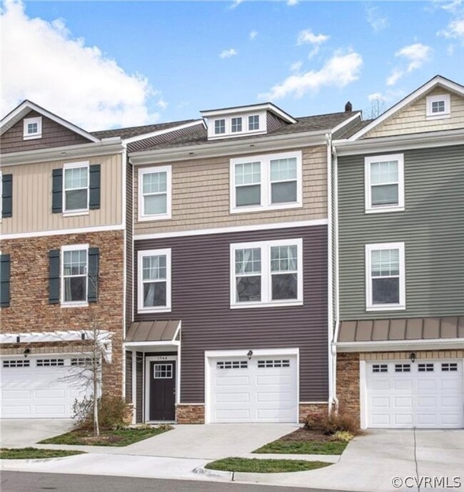 Townhome / multi-family property featuring a garage