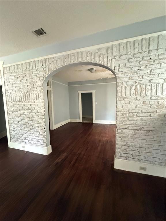 Hall with visible vents, baseboards, wood finished
