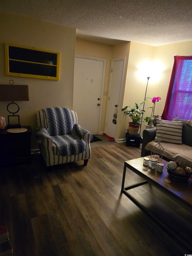 Living room with a textured ceiling and wood finis