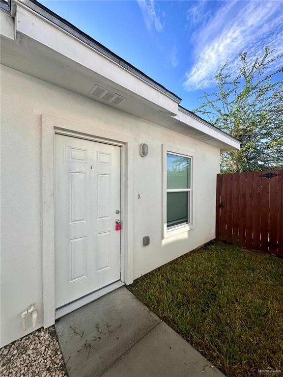 Entrance to property featuring stucco siding