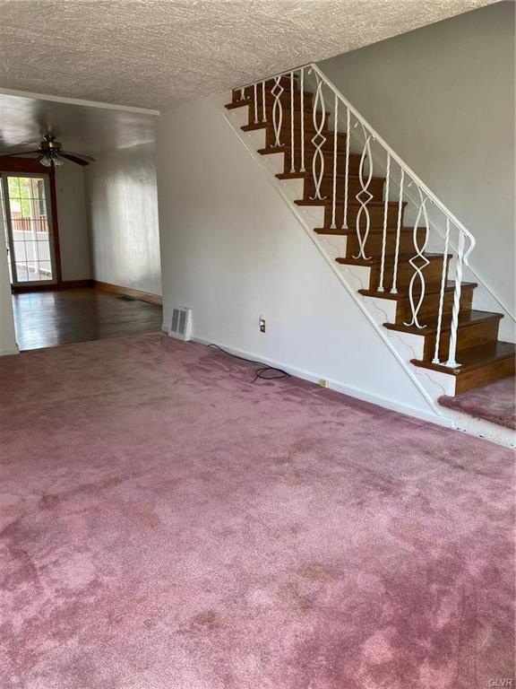 Living room with staircase to second floor. Dining