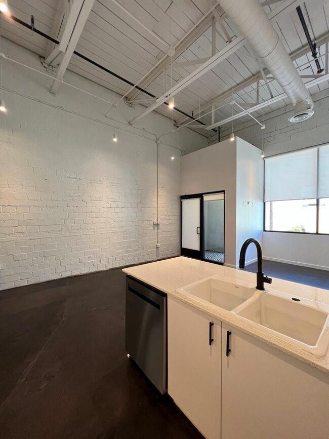 Kitchen with white cabinetry, sink, and stainless 