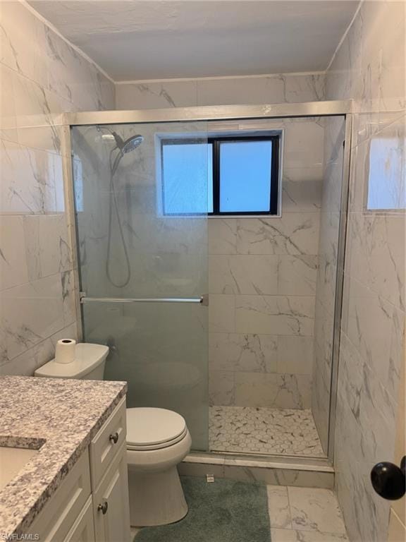 Full bath with vanity, marble finish floor, a marble finish shower, and toilet