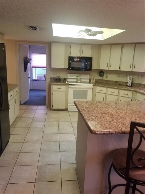 Kitchen leads out to the Florida room and patio