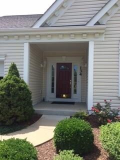 Pretty red front door with covered porch so you ne