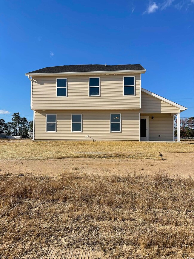 Rear view of house with a yard