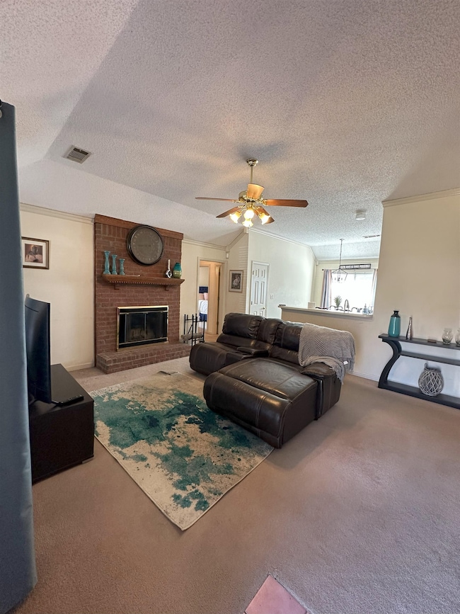 Living room with lofted ceiling, carpet, a firepla