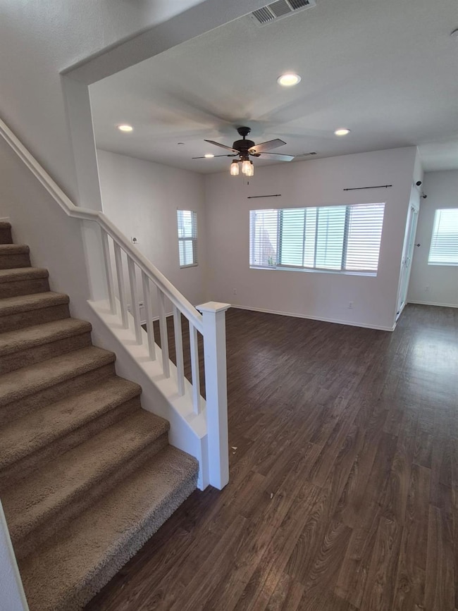 Stairs to upper level and view of the living room
