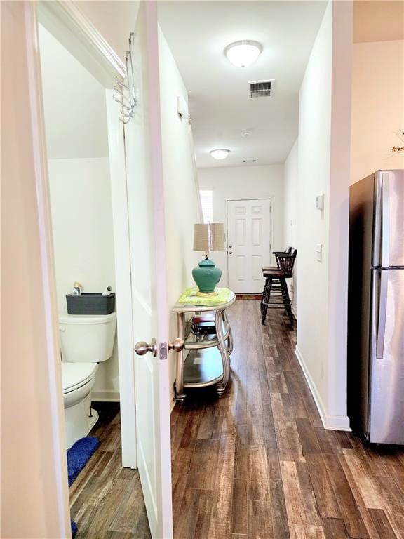 Hall with baseboards, dark wood-style floors, and 