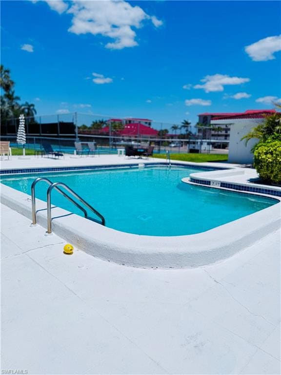 Pool with fence and a patio area