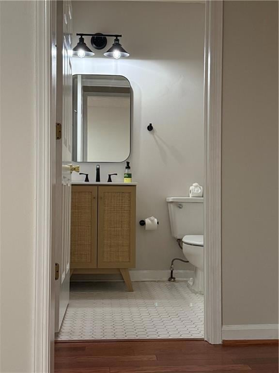 Half bath featuring vanity and light wood-style flooring