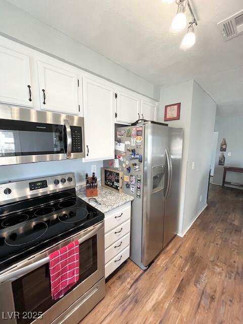 Kitchen with stainless steel appliances, visible v