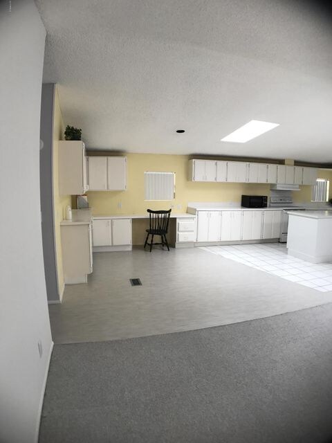 kitchen office area with cabinets