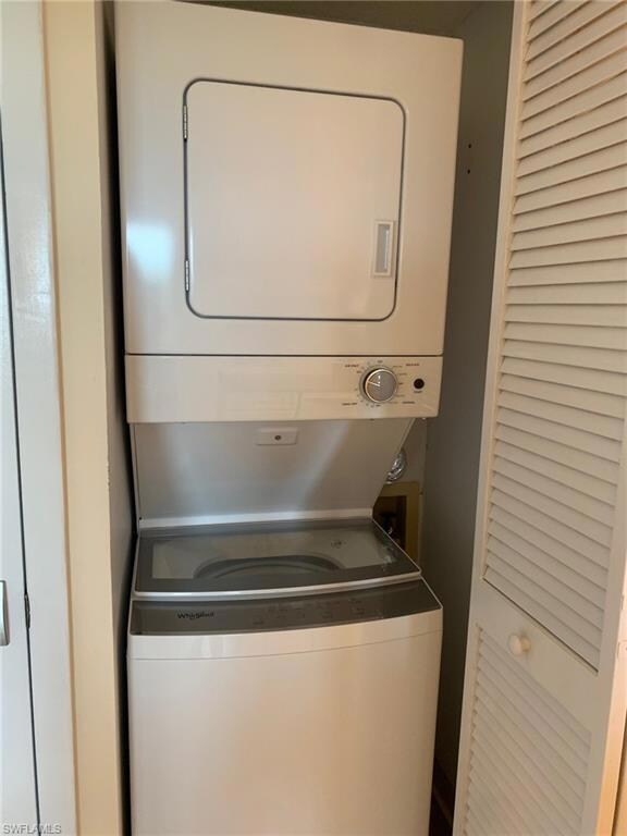 Laundry area featuring stacked washing machine and dryer