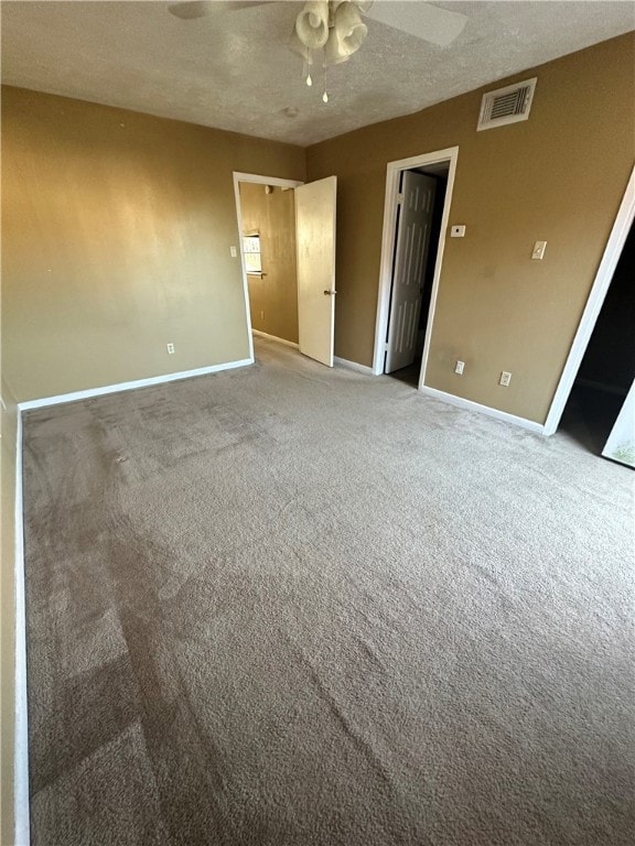 Empty room featuring a textured ceiling, visible v