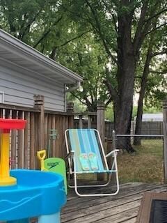 Front entry's deck is just the right place for getting out in the sun but discreetly between the house and the garage.