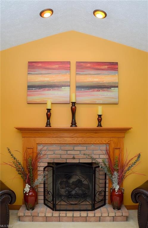 Recessed lighting above the fireplace in the Great