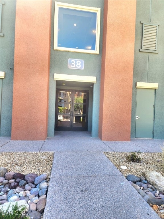 Entrance to property with french doors and stucco