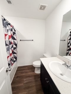 Bathroom featuring vanity, dark wood-type flooring, and shower / bath combo with shower curtain