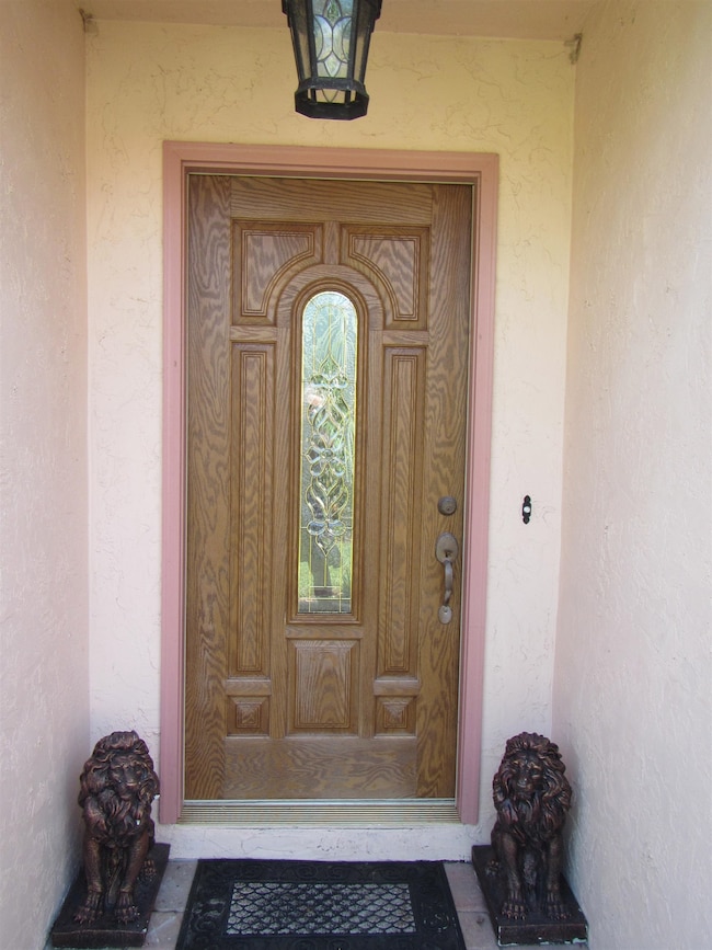 Doorway to property with stucco siding