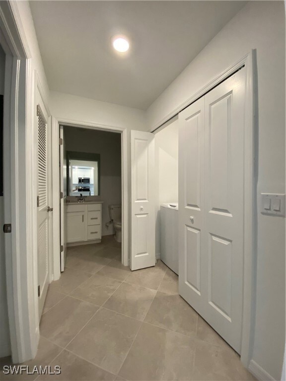 Corridor featuring light tile patterned flooring
