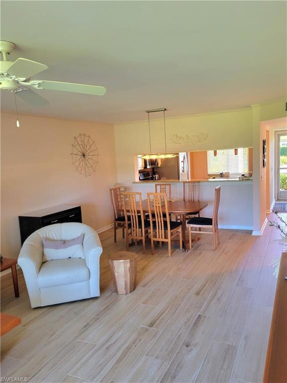 Dining space featuring light wood-type flooring and a ceiling fan