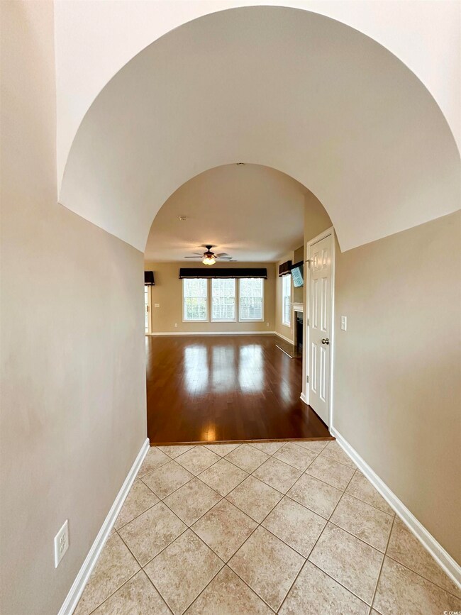 Corridor featuring light tile patterned flooring, 