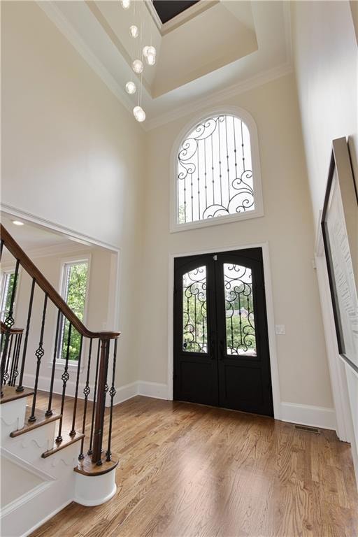The soaring two-story foyer features a dramatic ir