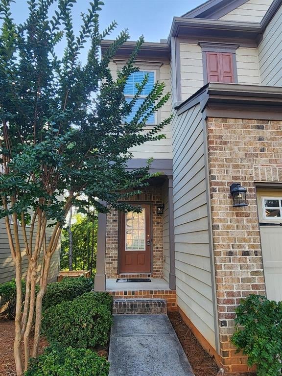 Entrance to property featuring brick siding