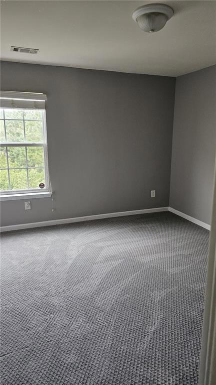 Room featuring carpet flooring and baseboards