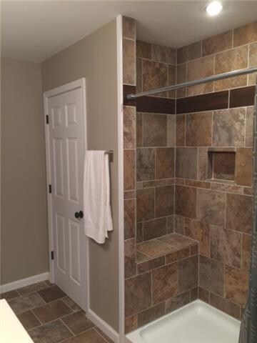Tiled in shower with bench in master bath