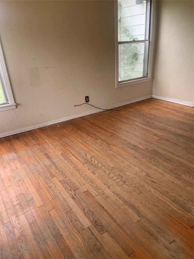 Spare room featuring hardwood floors