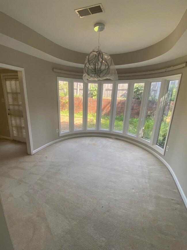Unfurnished dining area featuring baseboards, carp