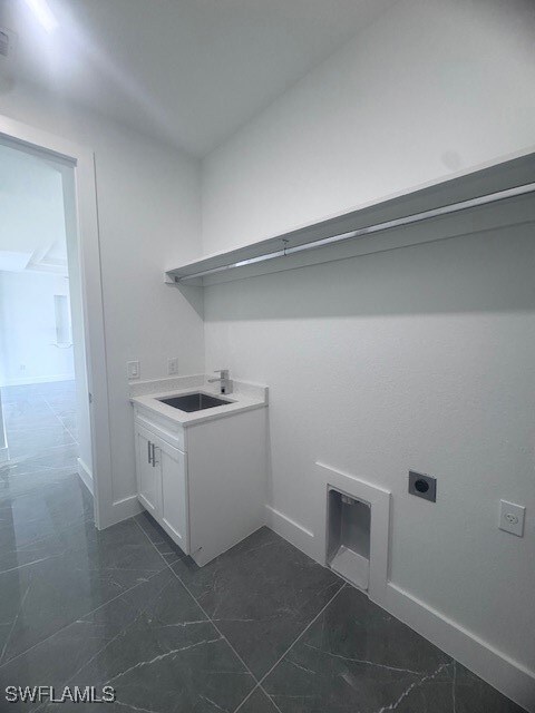 Laundry room featuring hookup for an electric drye