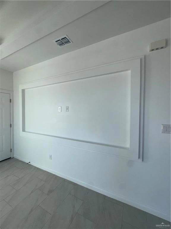 Spare room featuring baseboards