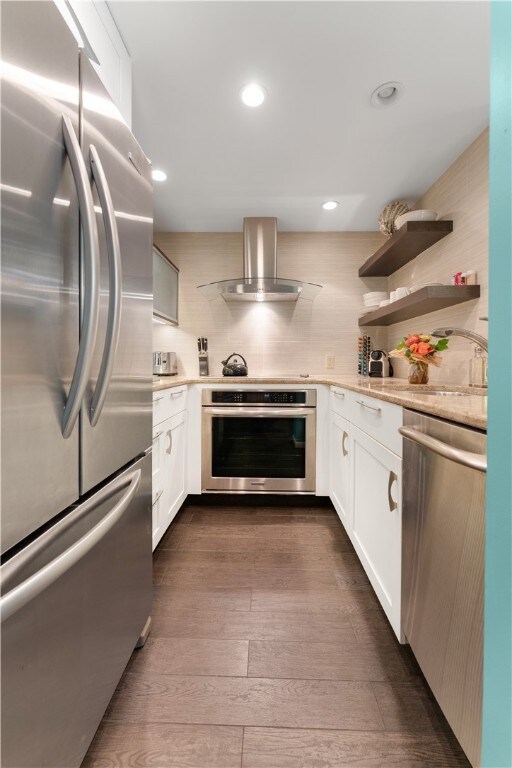 Ultra chic eat-in kitchen with quartz countertops ... stainless steel appliances ...