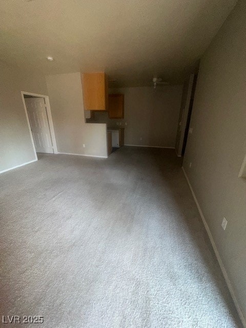 Unfurnished living room featuring baseboards and l