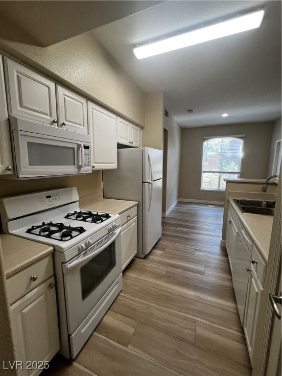 Kitchen featuring range, dishwashing machine, whit