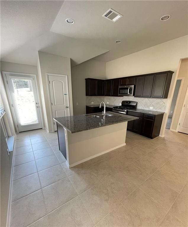 Kitchen with stainless steel appliances, dark sto